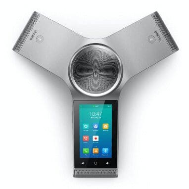 A smart phone is sitting on top of a speaker.