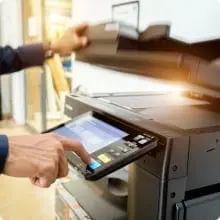 A person using a printer to print something.