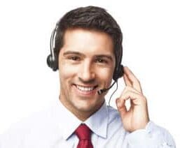 A man wearing headphones and smiling for the camera.