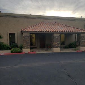 A building with a large roof and a brick wall.